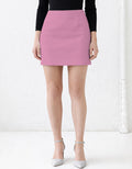 Person wearing a pink mini skirt with a white background