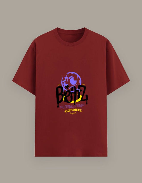 Red t-shirt with graphic design and text on a beige background