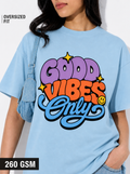 Person wearing a light blue t-shirt with 'Good Vibes Only' text design.