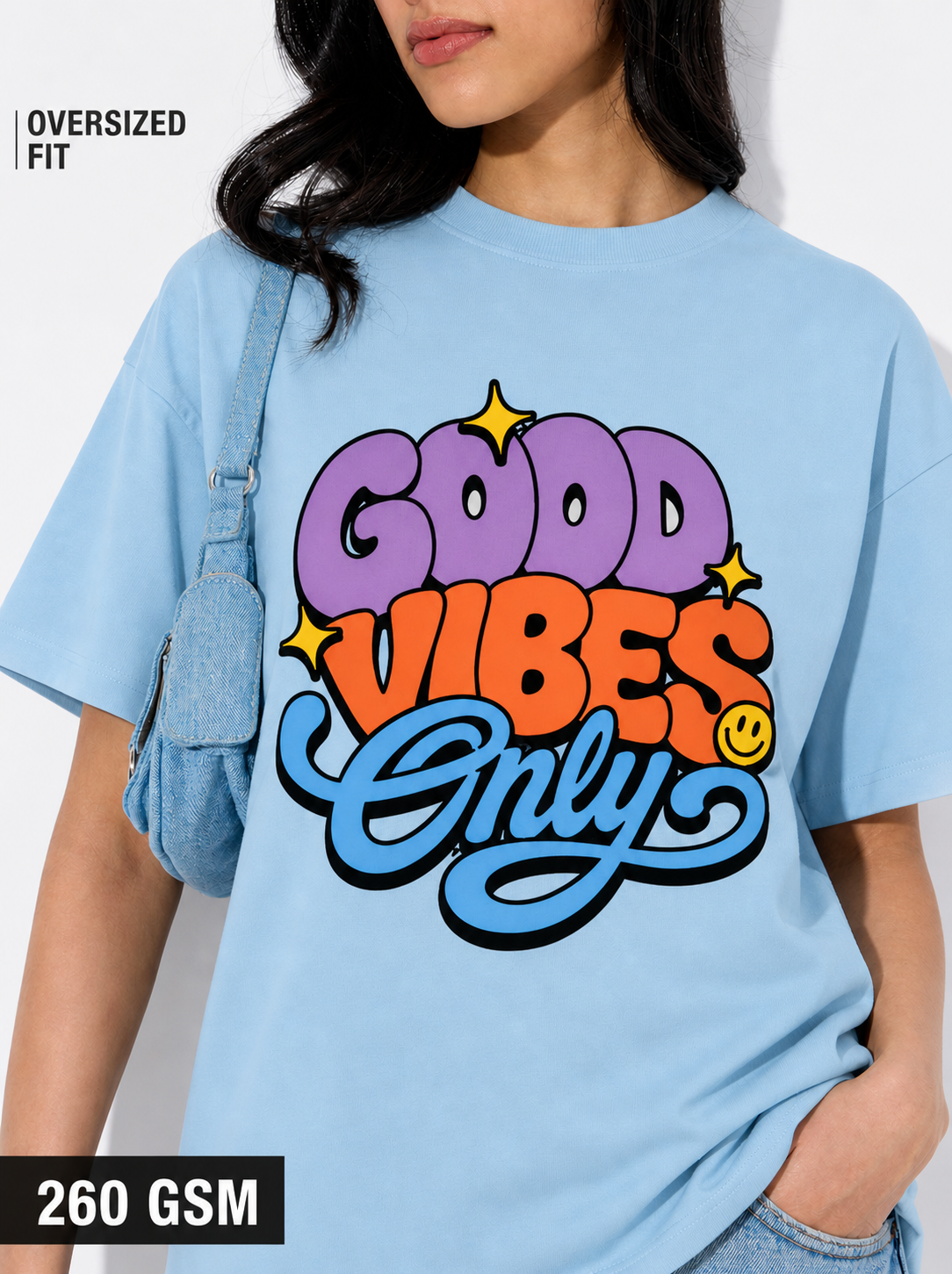 Person wearing a light blue t-shirt with 'Good Vibes Only' text design.