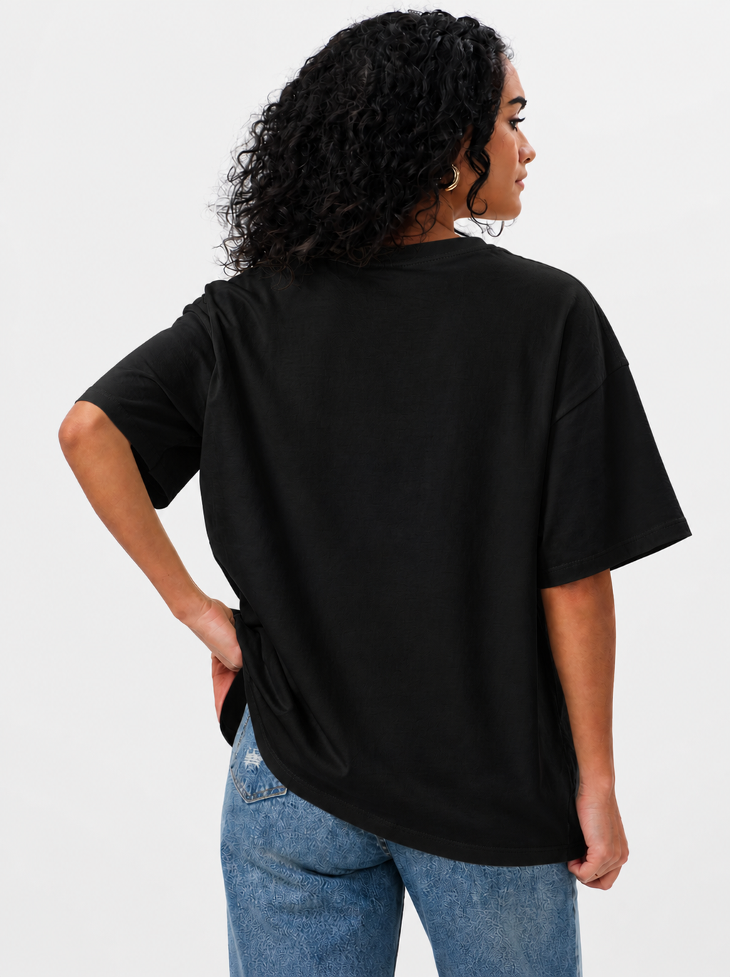 Person wearing a black t-shirt and blue jeans on a white background