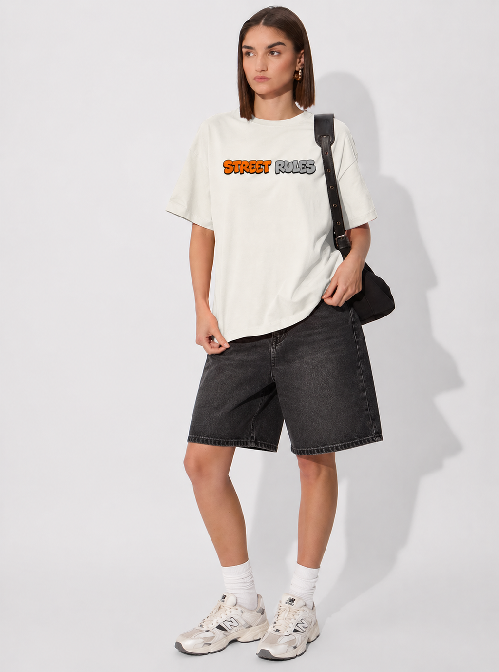 Person wearing a white t-shirt with text and black shorts on a white background