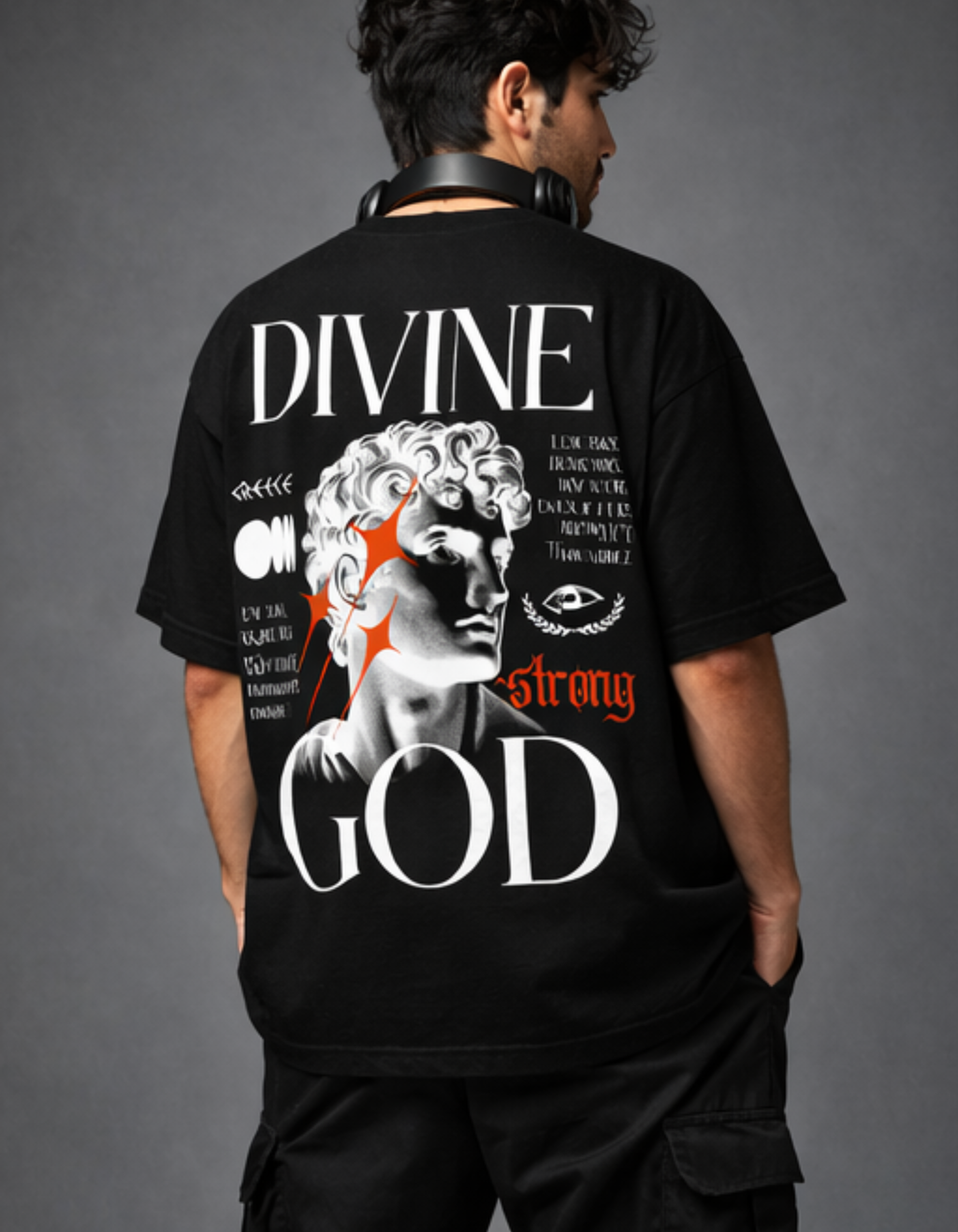 Person wearing a black t-shirt with 'Divine Strong God' design on the back against a gray background