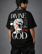 Person wearing a black t-shirt with 'Divine Strong God' design on the back against a gray background