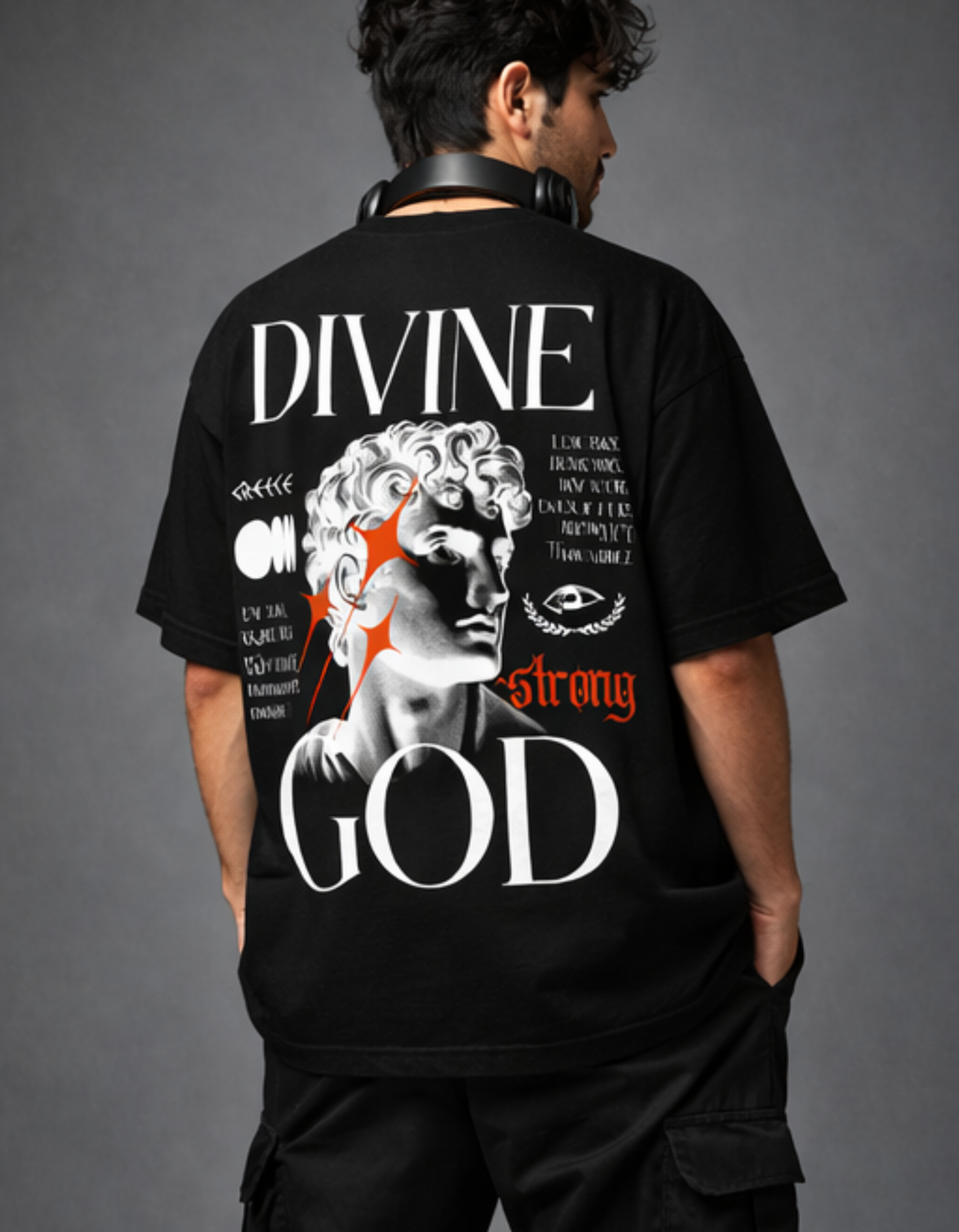 Person wearing a black t-shirt with 'Divine Strong God' design on the back against a gray background