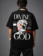 Person wearing a black t-shirt with 'Divine Strong God' design on the back against a gray background