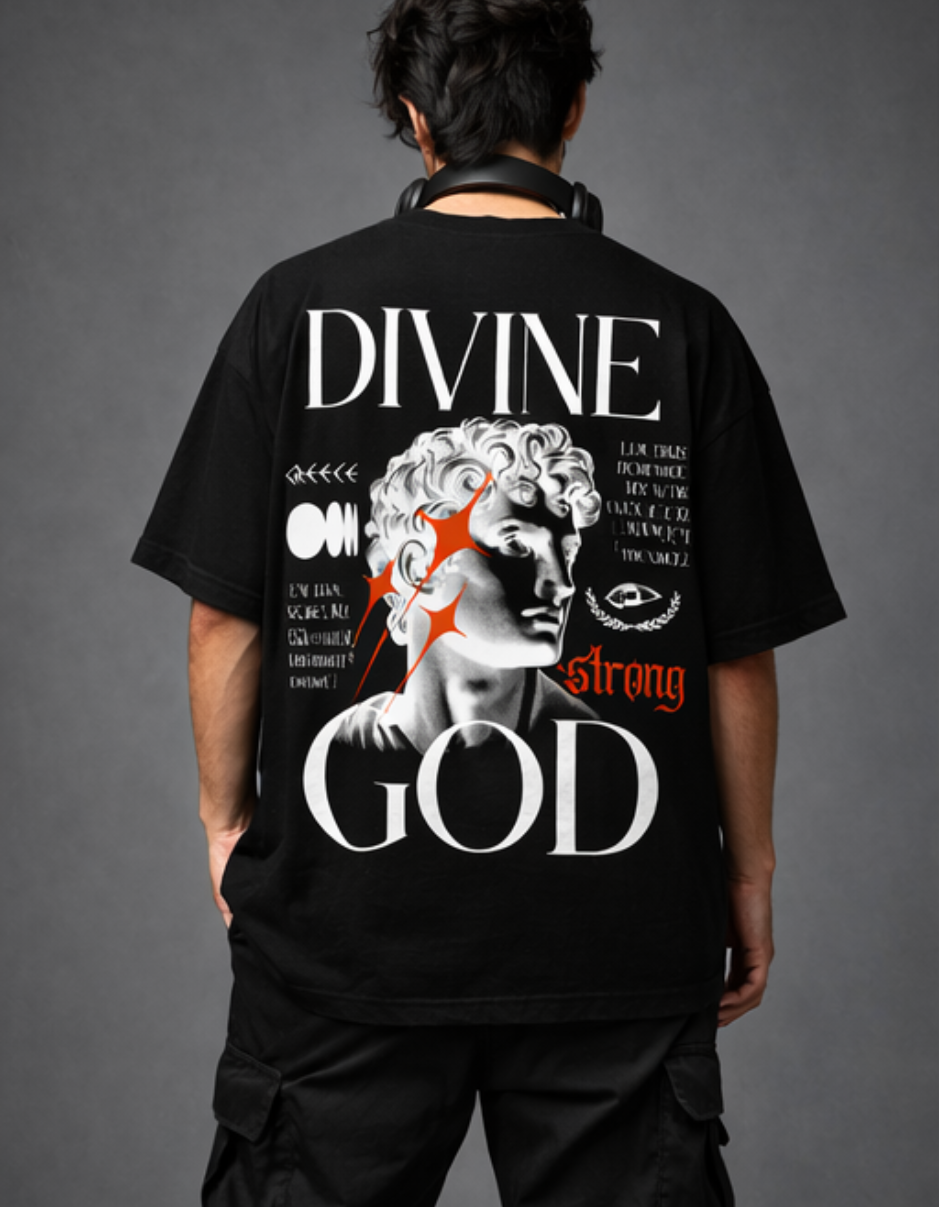 Person wearing a black t-shirt with 'Divine Strong God' design on the back against a gray background