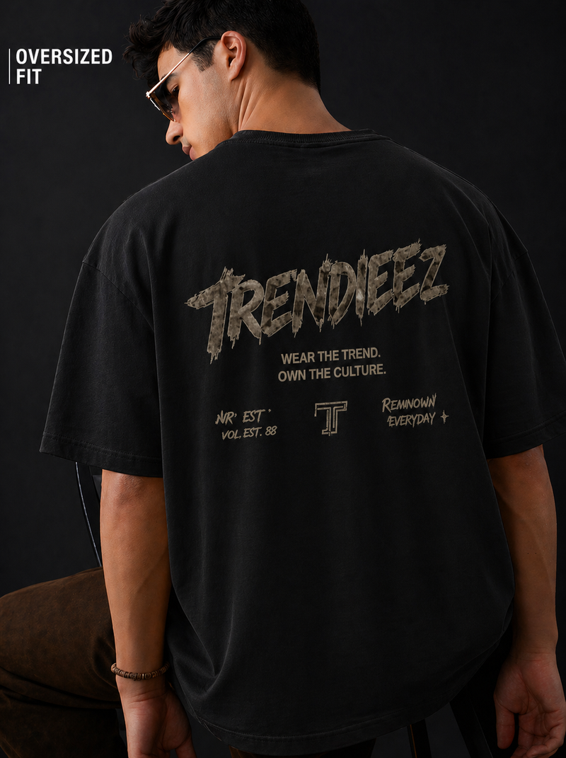 Person wearing a black oversized t-shirt with 'TRENDIEEZ' branding on the back.