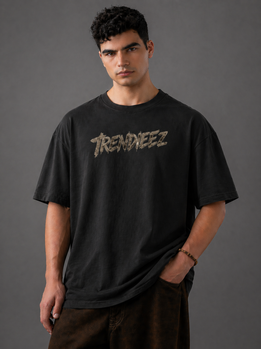Man wearing a black t-shirt with 'Trendiez' logo against a gray background