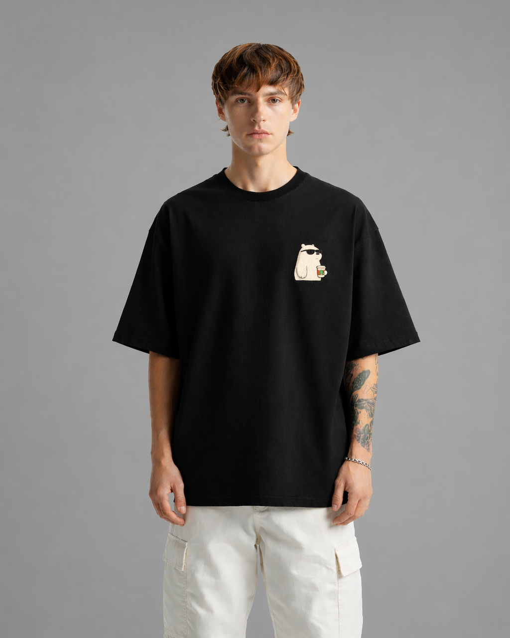 Person wearing a black t-shirt with a graphic design on a gray background