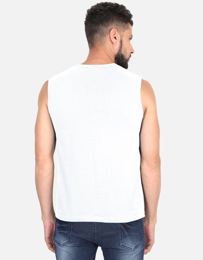 Man wearing a white sleeveless shirt and blue jeans on a light gray background