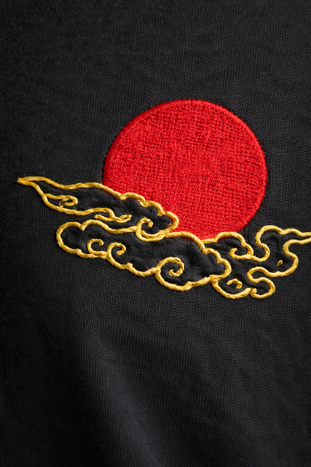 Embroidered red circle with gold waves on a black background
