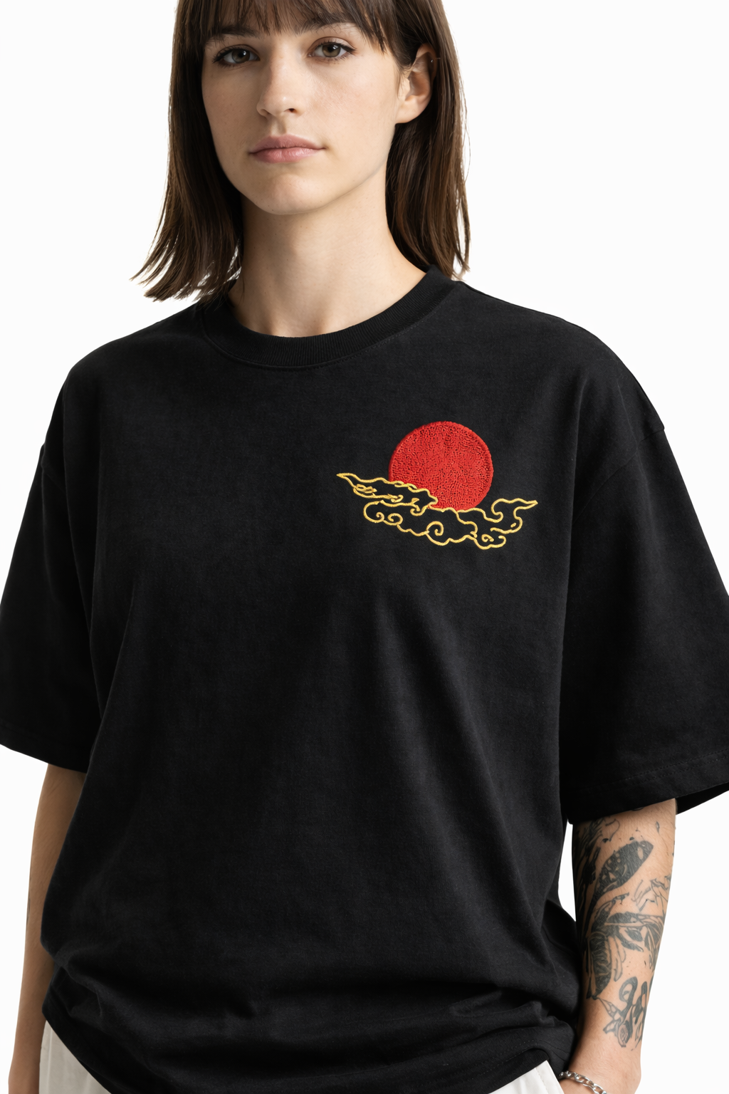 Person wearing a black t-shirt with a red and yellow graphic design on a white background