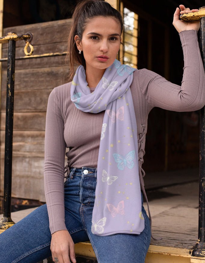 Woman wearing a light purple scarf with butterfly patterns, sitting on a wooden staircase.