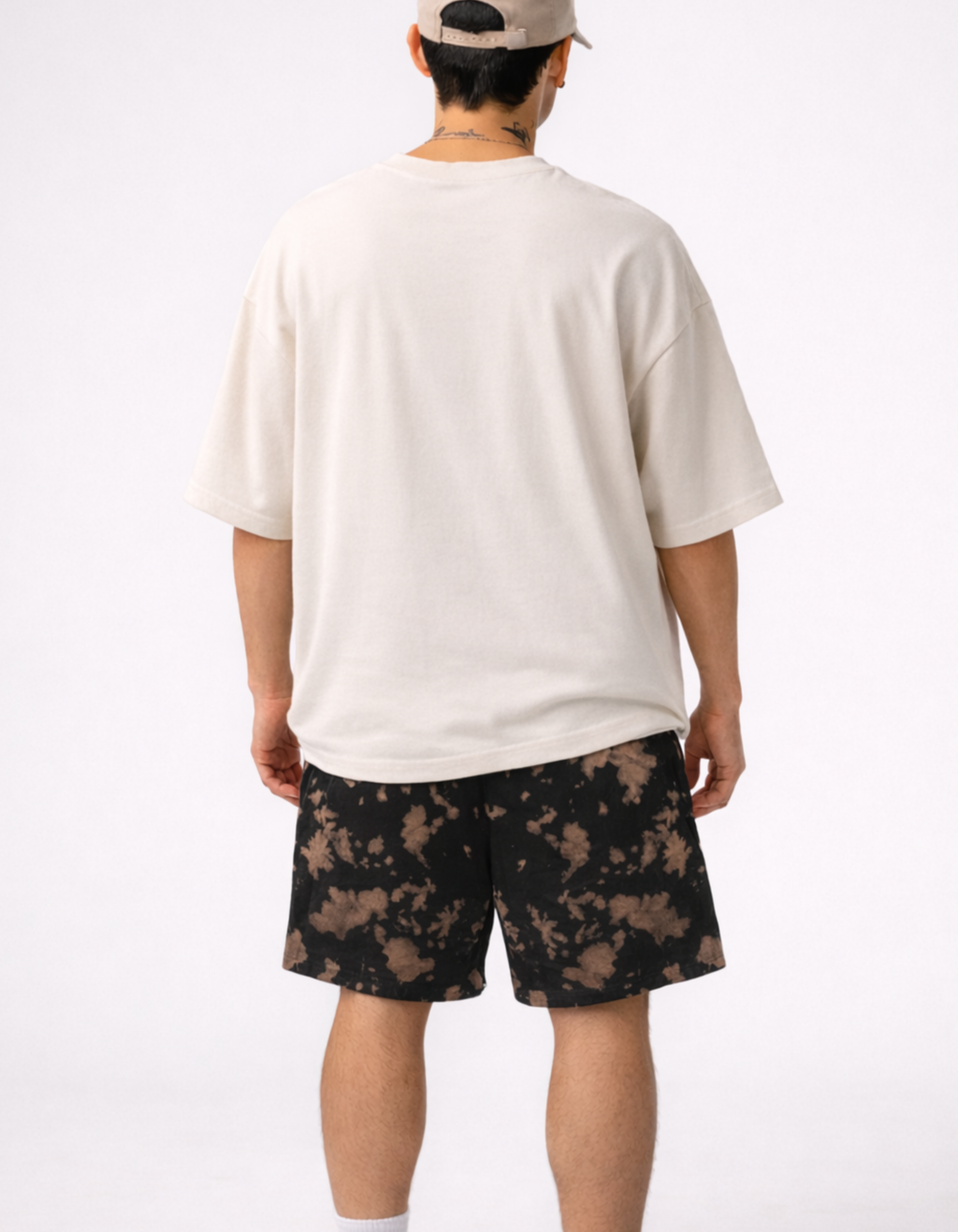 Person wearing a white t-shirt and camouflage shorts on a white background