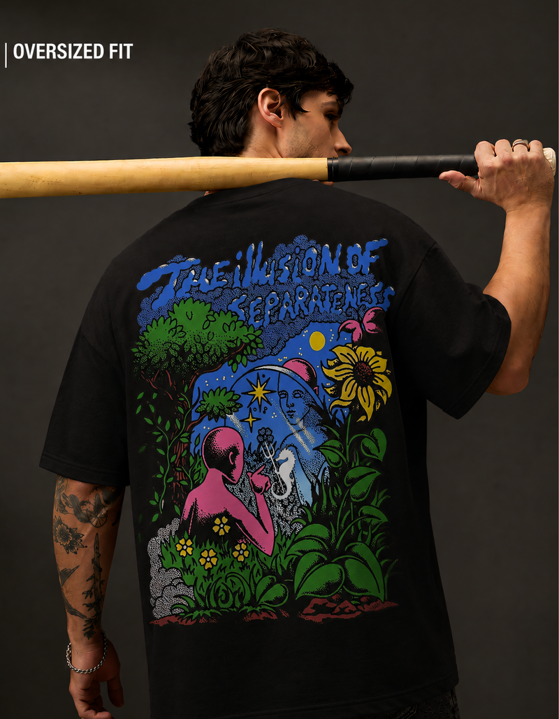 Person wearing a black t-shirt with colorful graphic design, holding a baseball bat.
