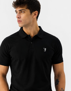 Man wearing a black polo shirt with a small logo on a light gray background