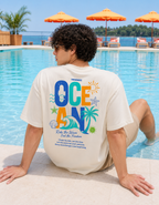 Person wearing a t-shirt with ocean-themed design by a poolside