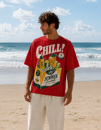 Man wearing a red t-shirt with 'Chill!' and summer essentials graphic on a beach.