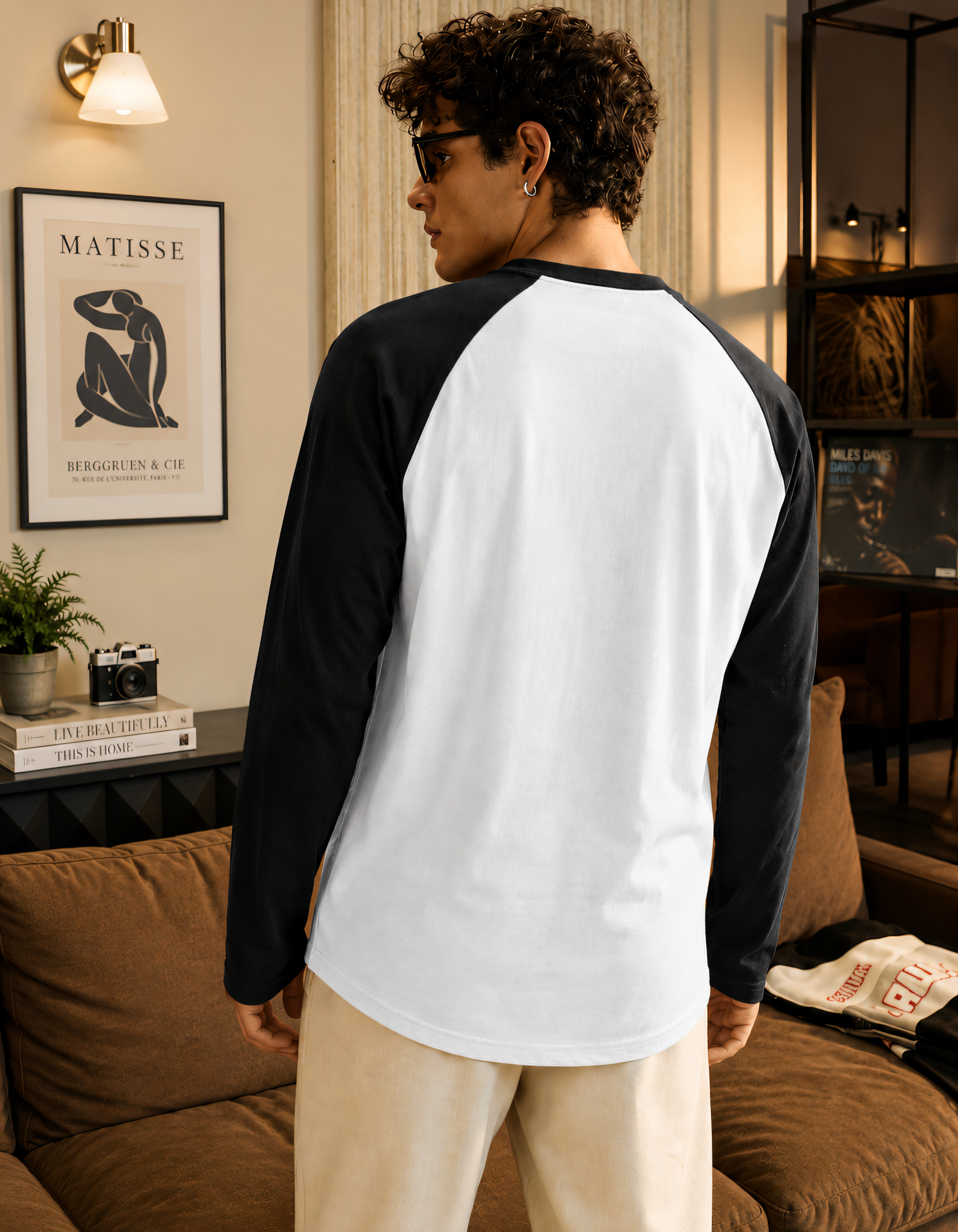 Person wearing a black and white baseball shirt in a living room setting