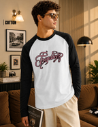 Man wearing a black and white 'Freddie' baseball shirt in a living room.