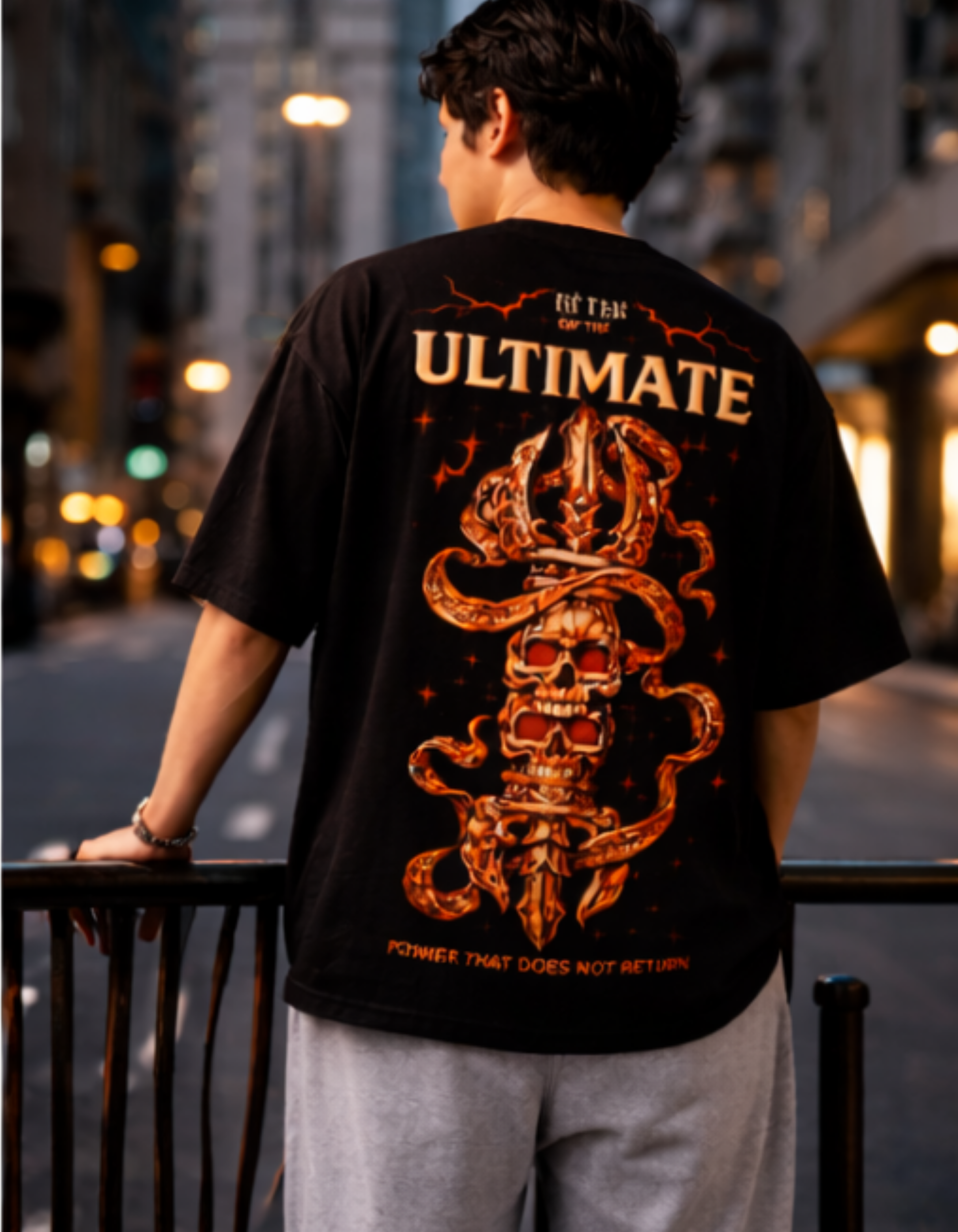 Person wearing a black t-shirt with a graphic design and text, standing on a street at night.